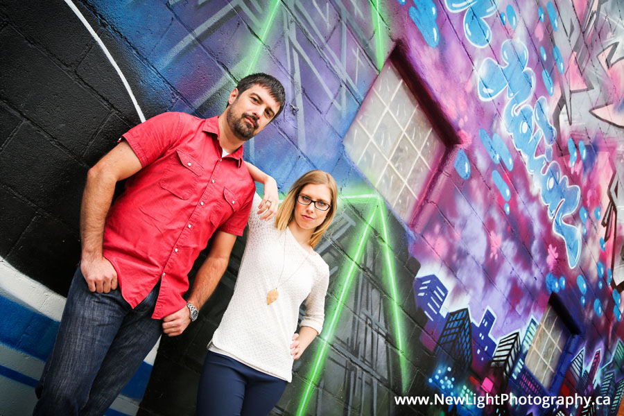 Outdoor portrait of couple by graffiti