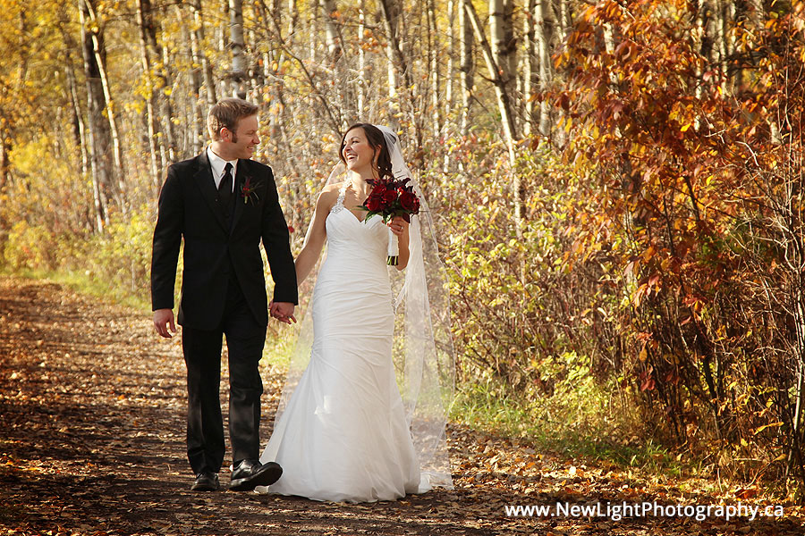 Wedding photo couple laughing in the fall leaves